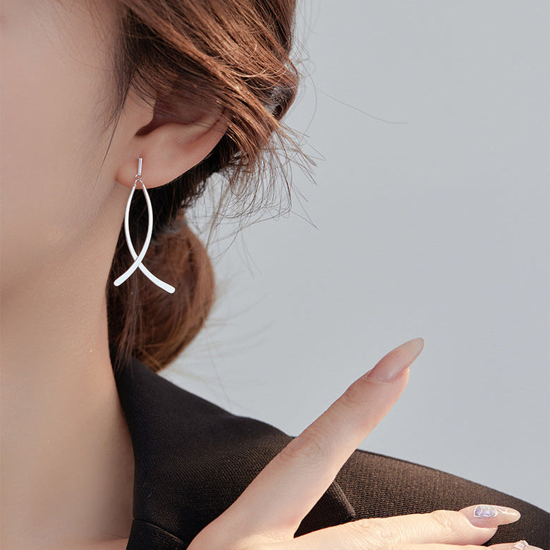 Earring being worn with a neutral background
