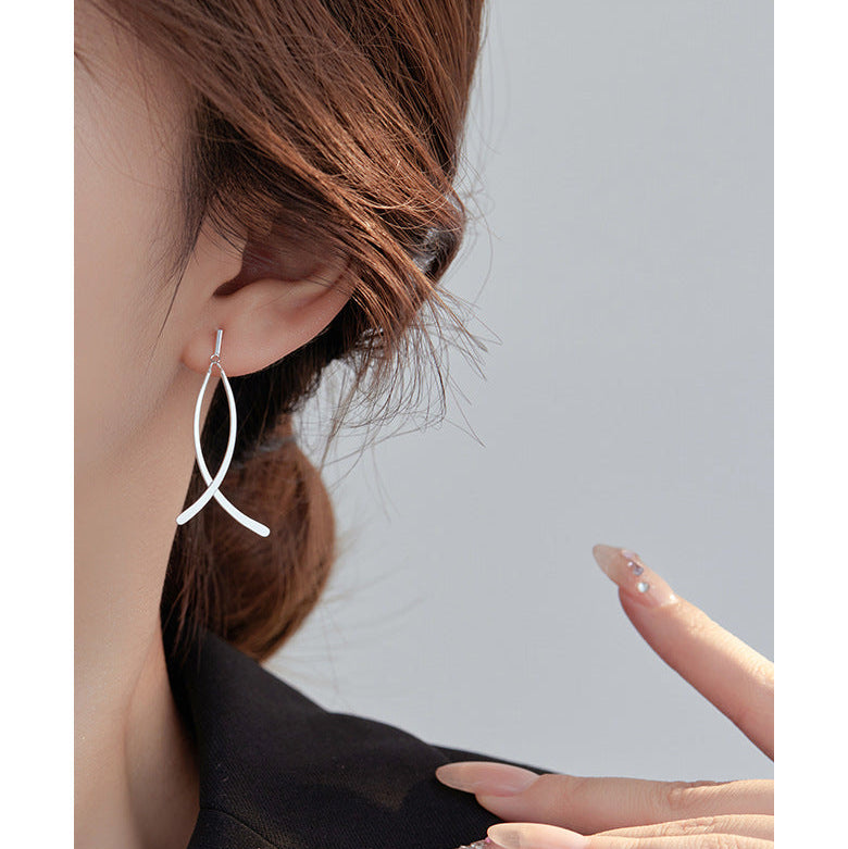 Earring worn by a person with a neutral background
