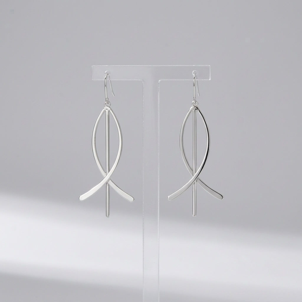 Person wearing a silver hoop earring with a blurred background