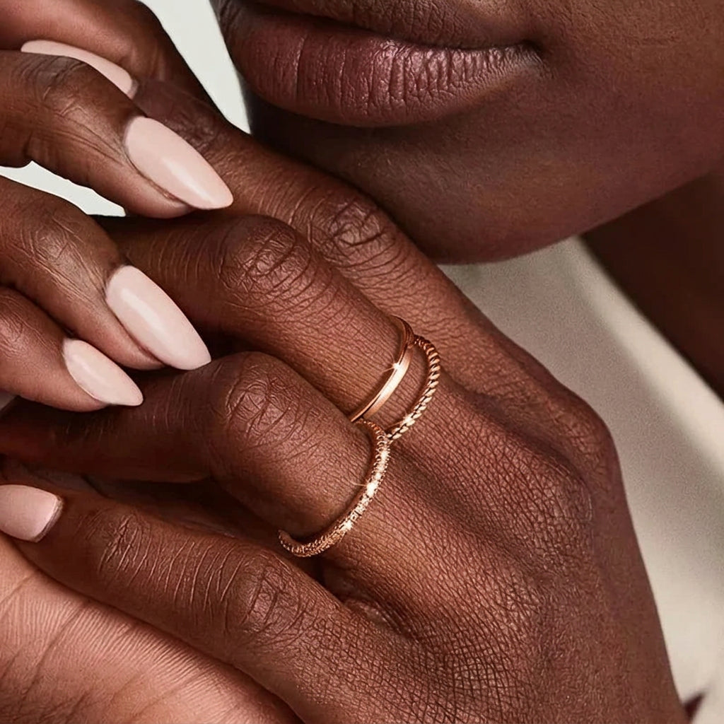 Close-up of hands wearing silver rings with a '925 Silver Plated' quality badge.