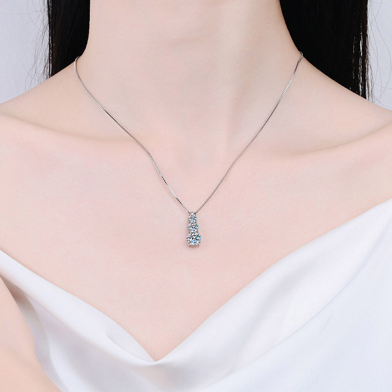 Silver necklace with a blue pendant on a mannequin